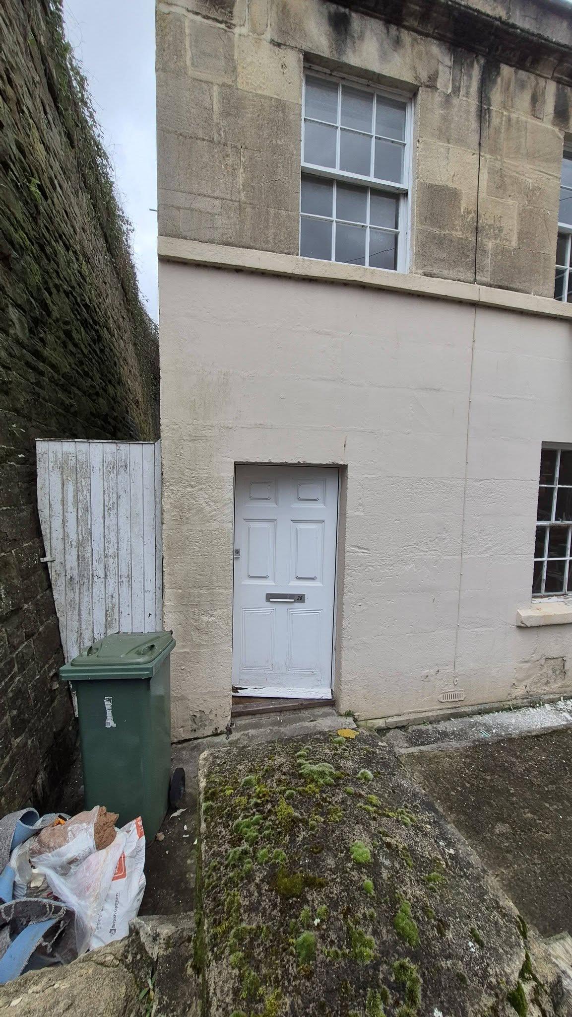 Rear of Georgian property in Bath with rendered ground floor and stone upper storey