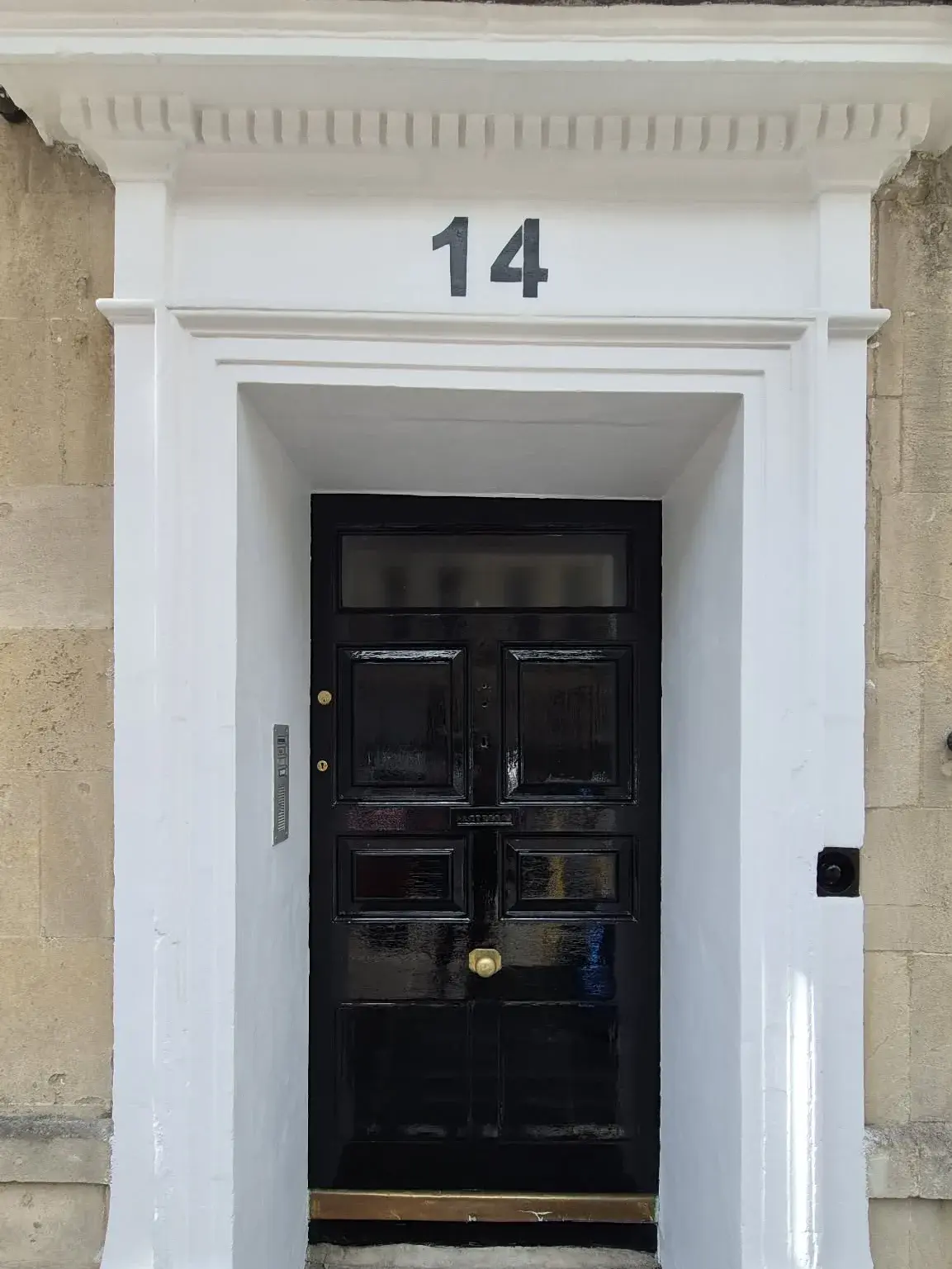Restored Georgian doorway with black gloss door and freshly painted white surround, Bath