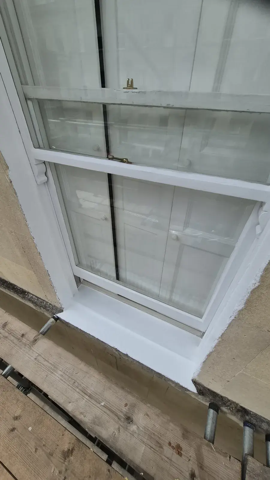 Restored Georgian sash window with freshly painted white frame, sill and reveal, Bath