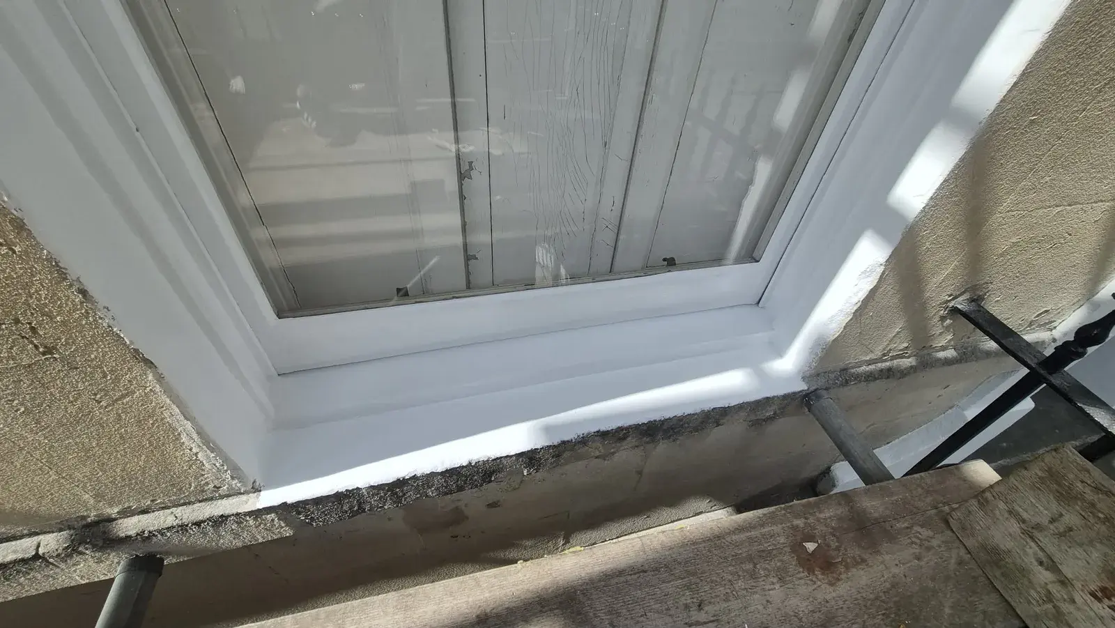The same window sill rebuilt, primed and repainted in white, Bath