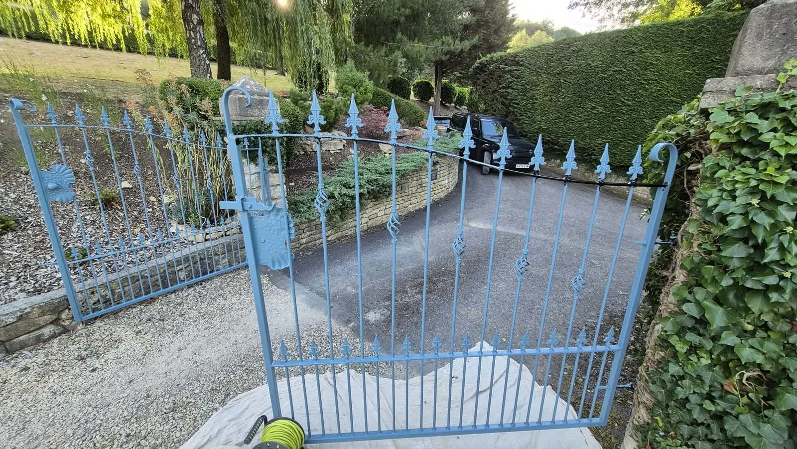 Wrought iron driveway gates coated in blue rust-inhibiting primer, Warleigh
