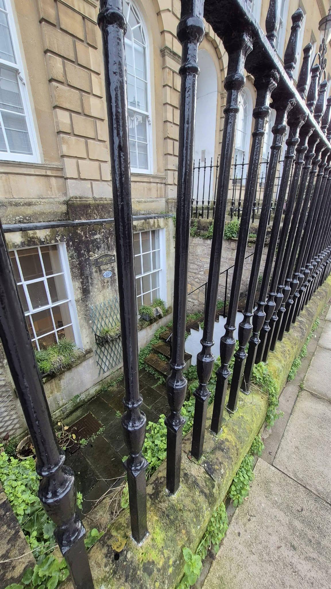 Stone building and railed area after restoration – Bath